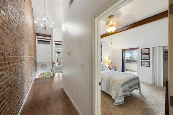 a living room with lots of furniture and kitchen view