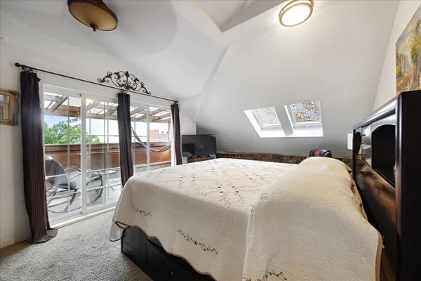 a view of a hallway with wooden floor and windows