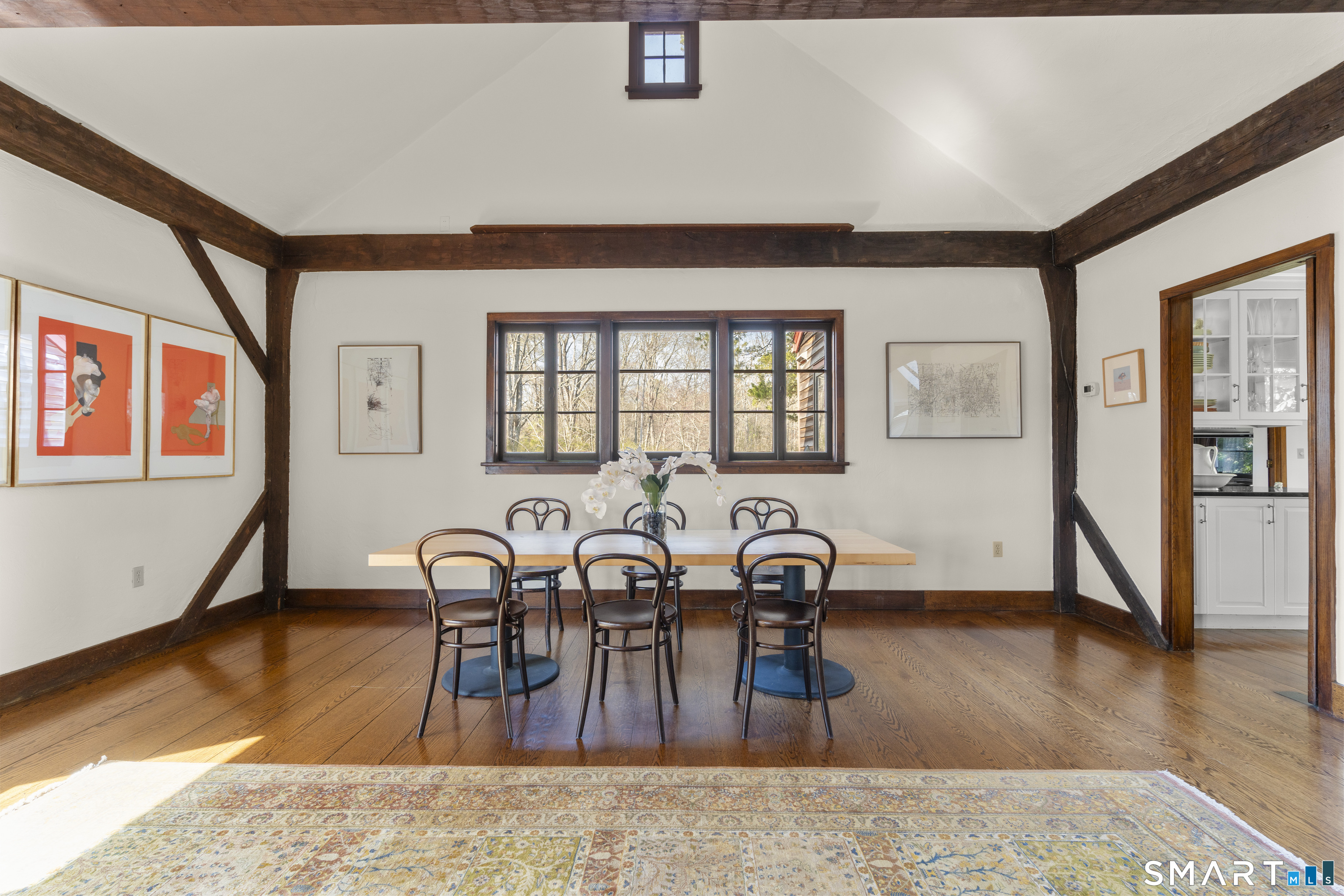 55-69 Sawmill Road Branford, CT 06405 - Photo 16 of 40 a living room with furniture a dining table and wooden floor