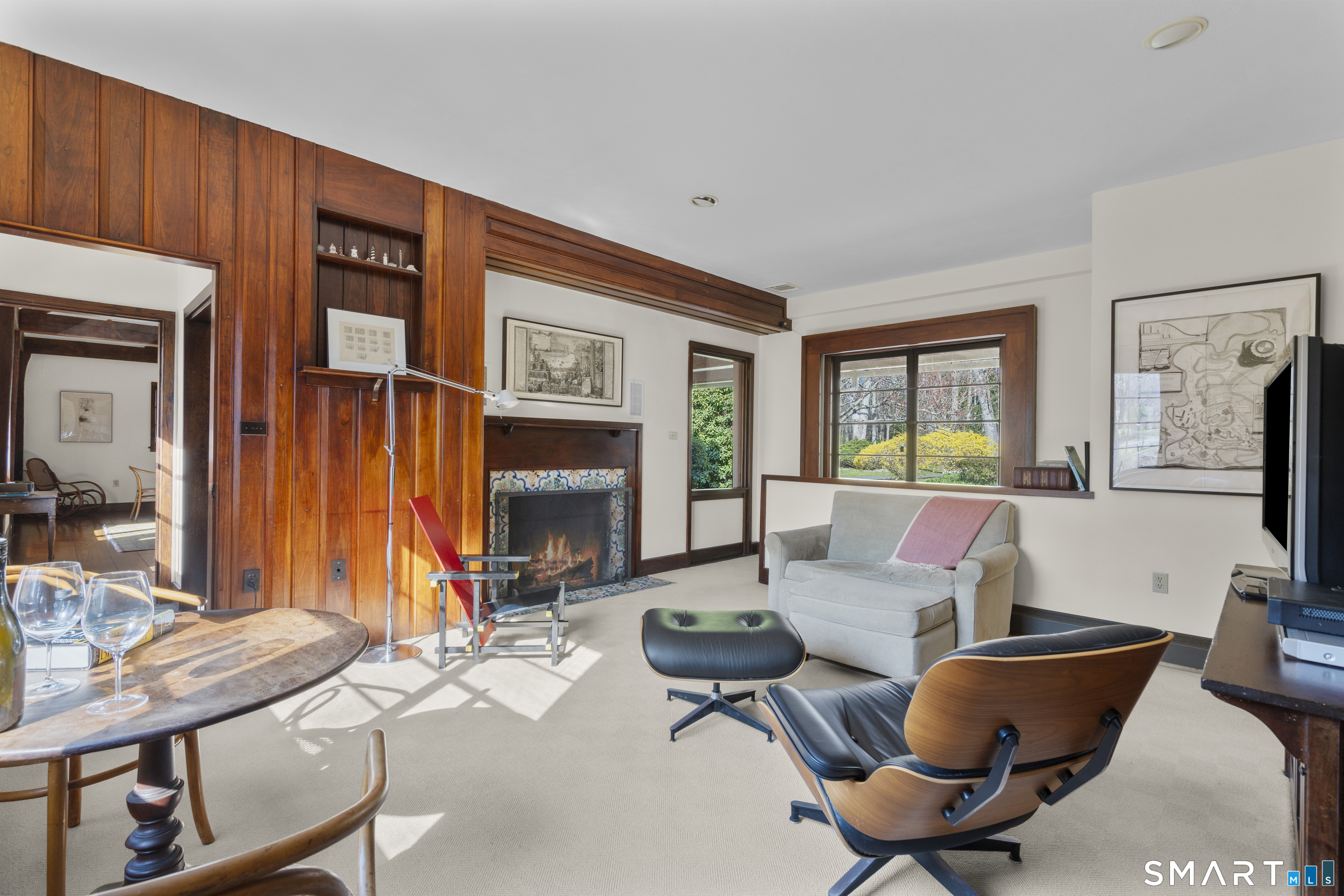 55-69 Sawmill Road Branford, CT 06405 - Photo 19 of 40 a living room with furniture a fireplace and a large window