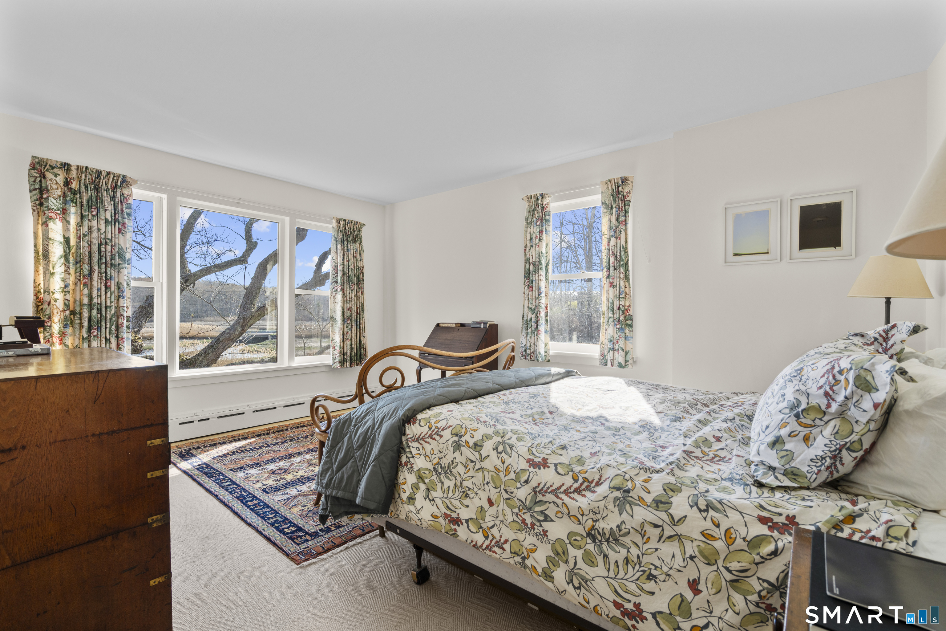 55-69 Sawmill Road Branford, CT 06405 - Photo 24 of 40 a bedroom with a bed and wooden floor