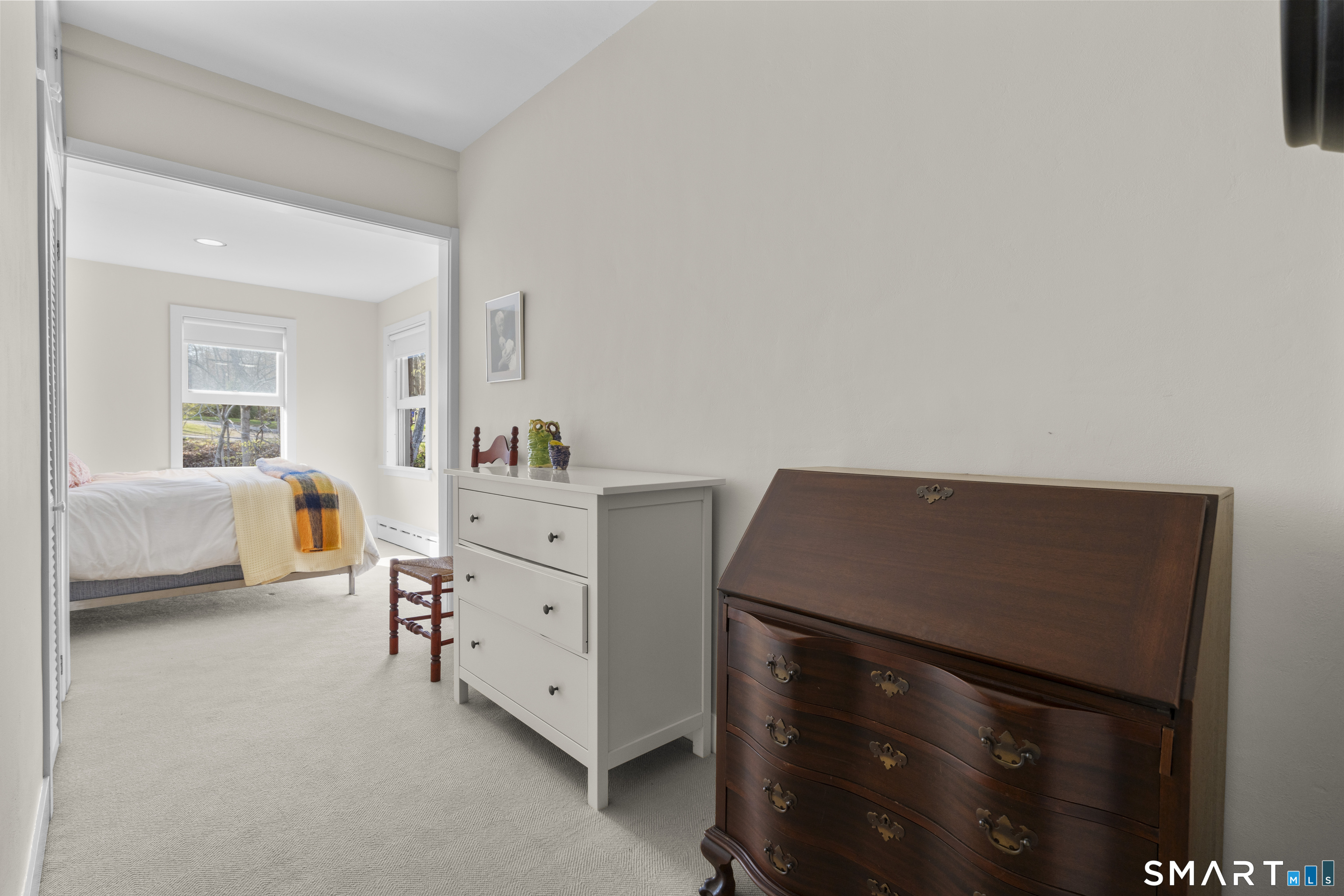 55-69 Sawmill Road Branford, CT 06405 - Photo 27 of 40 a bedroom with a bed and a chair