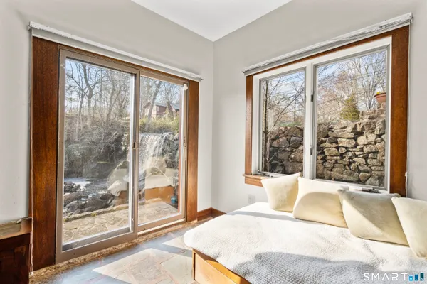 a bedroom with a large bed and a large window