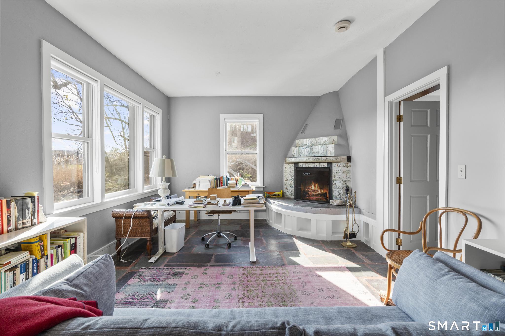 55-69 Sawmill Road Branford, CT 06405 - Photo 33 of 40 a living room with furniture and a fireplace