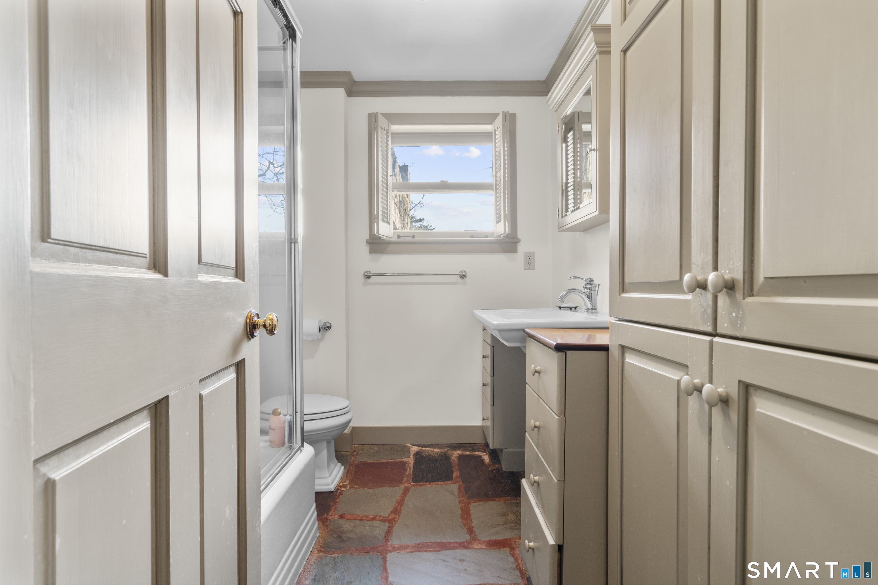55-69 Sawmill Road Branford, CT 06405 - Photo 34 of 40 a bathroom with a sink a toilet and a window