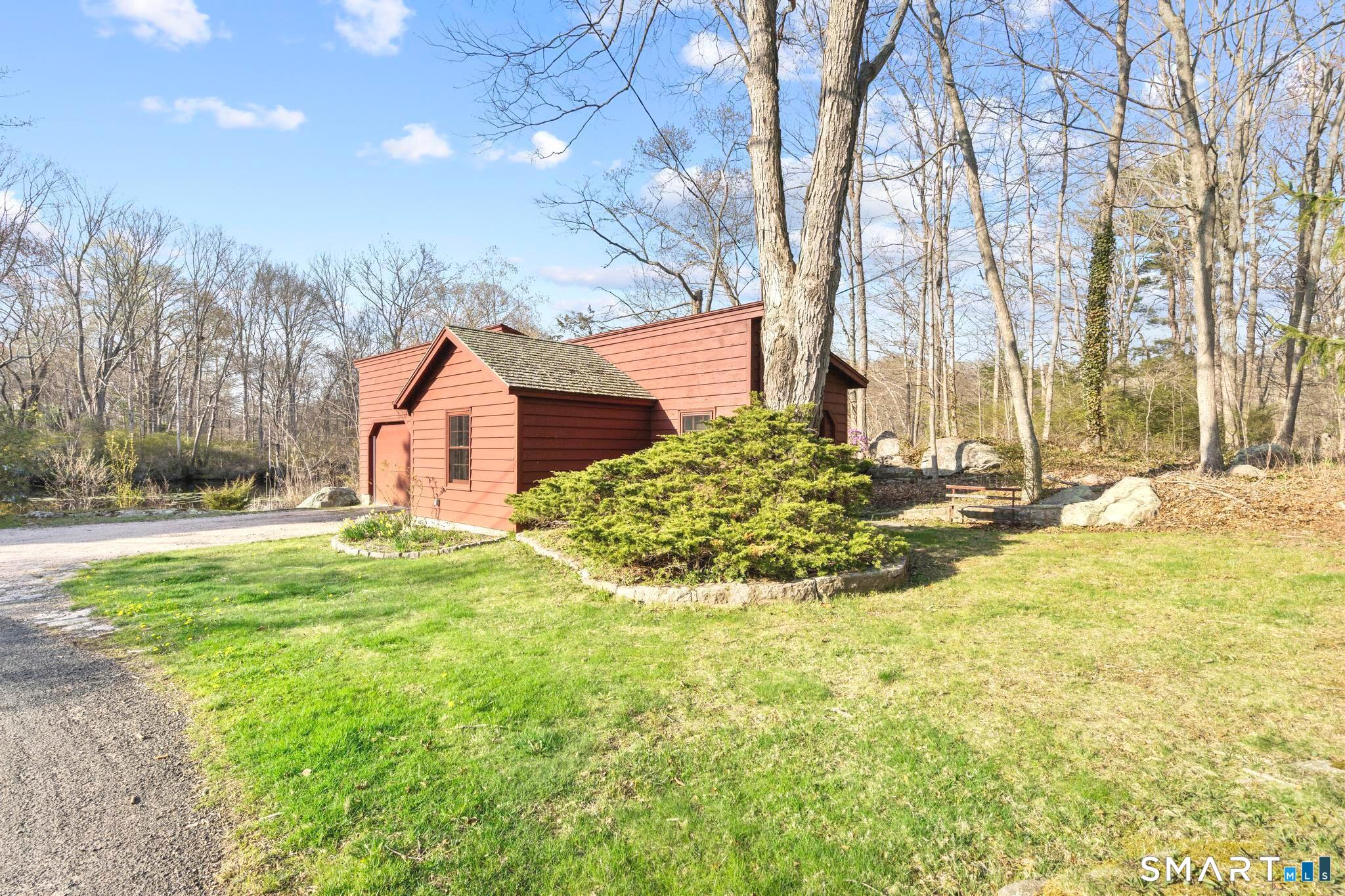 55-69 Sawmill Road Branford, CT 06405 - Photo 36 of 40 a view of a backyard with large trees