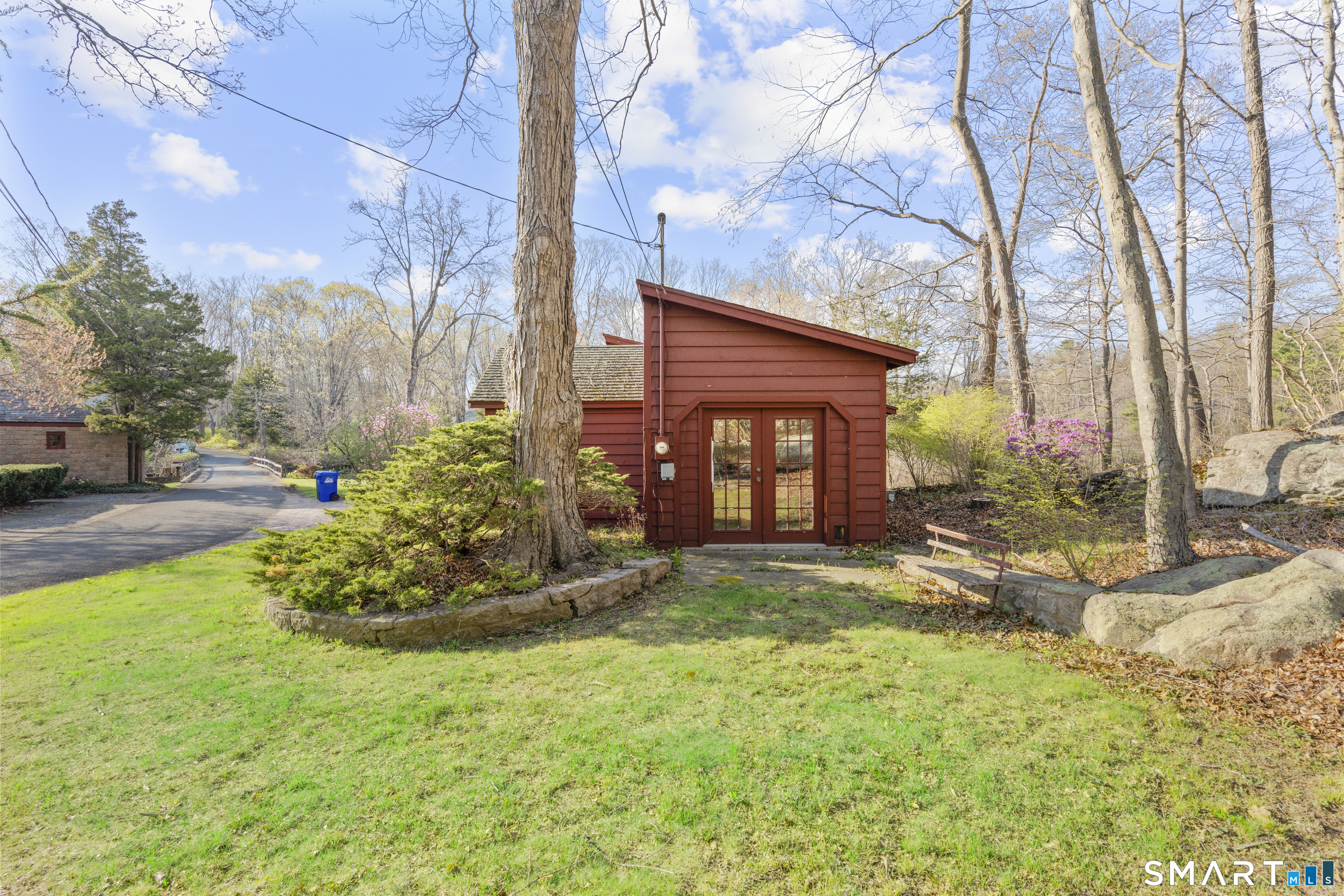 55-69 Sawmill Road Branford, CT 06405 - Photo 37 of 40 a view of a backyard with table and chairs and potted plants