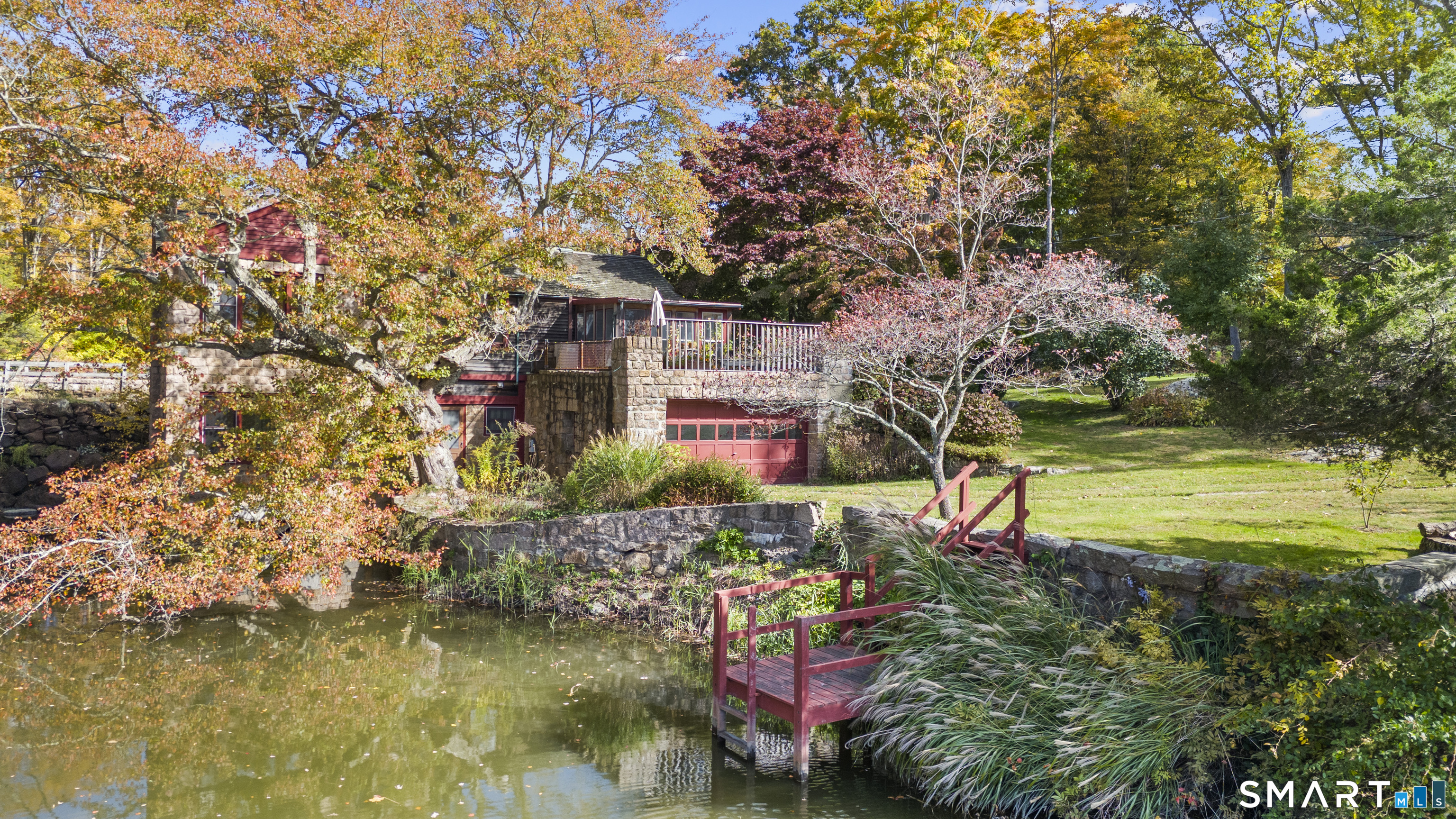 55-69 Sawmill Road Branford, CT 06405 - Photo 8 of 40 a backyard of a house with lots of green space and fountain