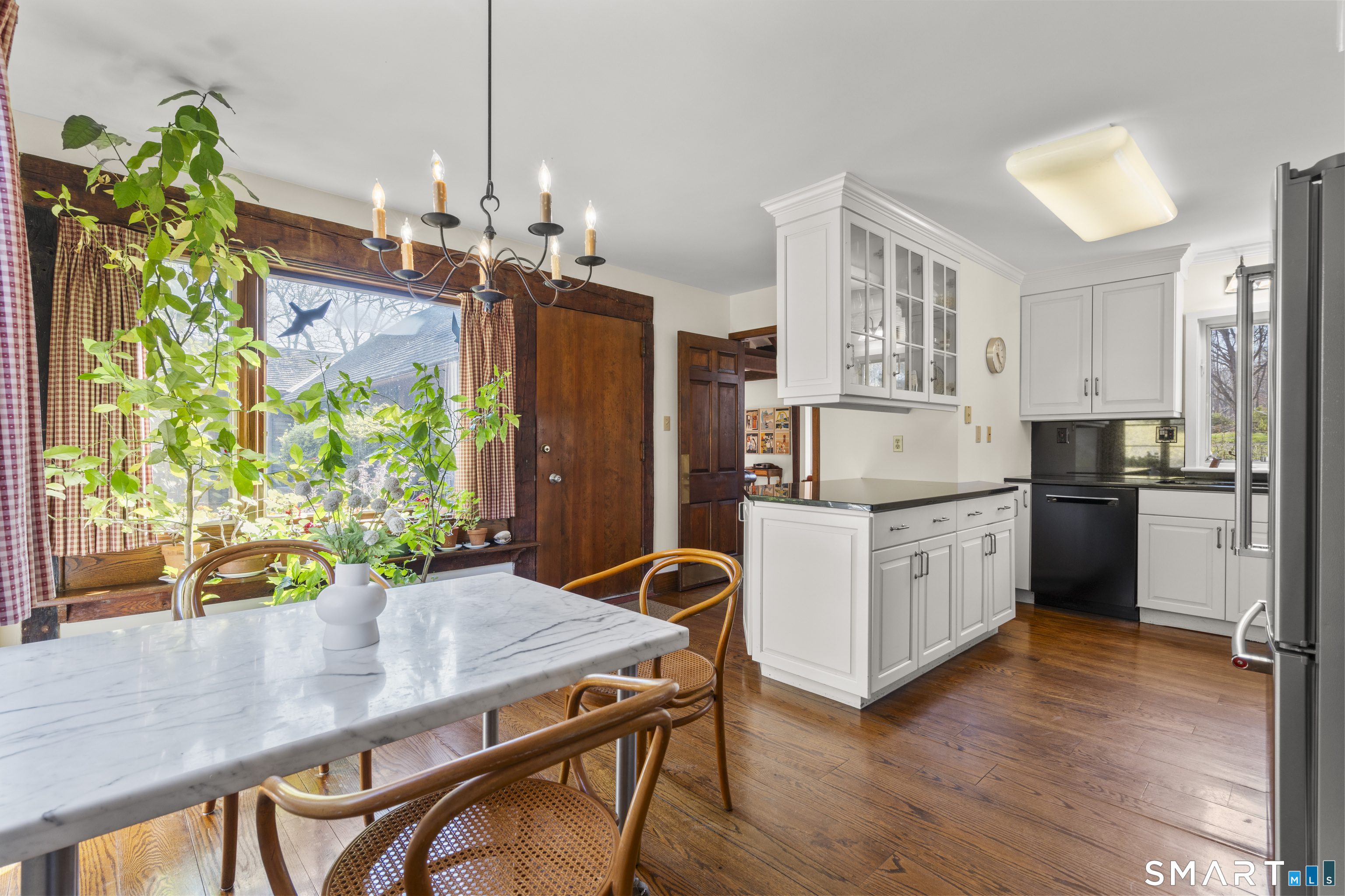 55-69 Sawmill Road Branford, CT 06405 - Photo 10 of 40 a kitchen with stainless steel appliances granite countertop a stove refrigerator and a wooden floor