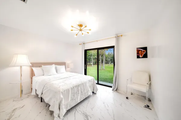 a bedroom with a bed and a chandelier