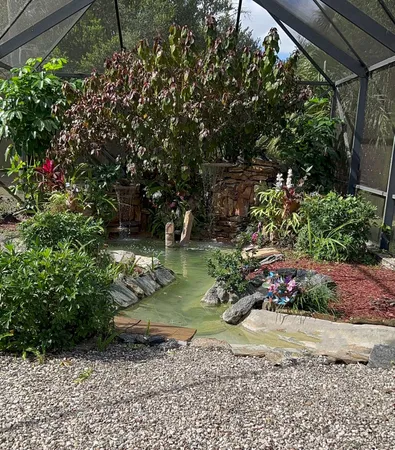 a garden with a tree in the background