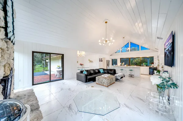 a large bedroom with bed and a window