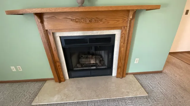 a view of an empty room with a fireplace