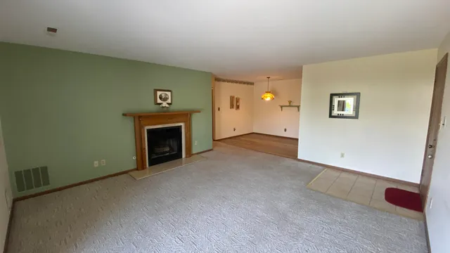 a view of empty room with fireplace