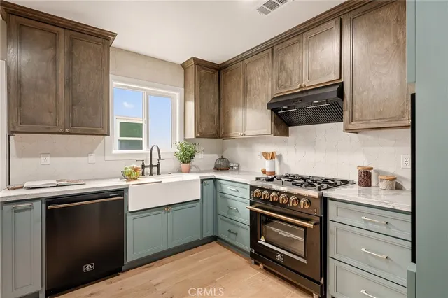 a kitchen with kitchen island a table and chairs