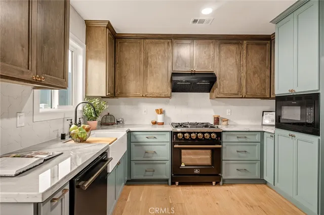 a kitchen with a sink stove and cabinets