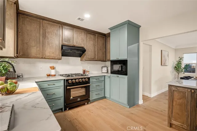 a kitchen with stainless steel appliances a stove sink and cabinets