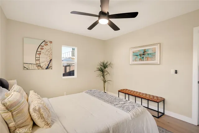 a bedroom with a large bed and a chandelier