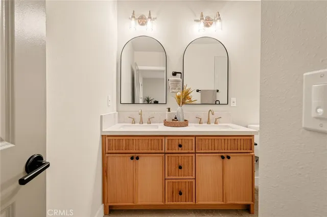 a bedroom that has a bed and a chandelier