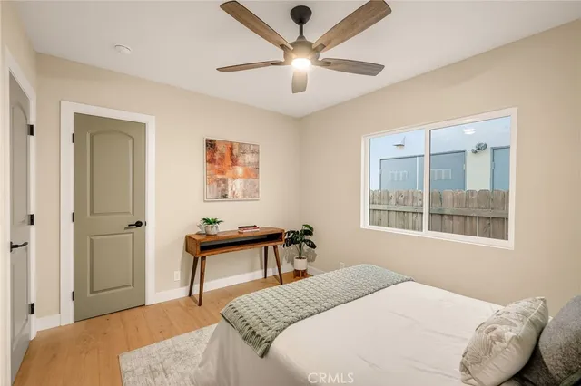 a bedroom with a large bed and a chandelier