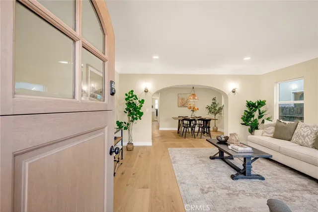 a living room with furniture and a potted plant