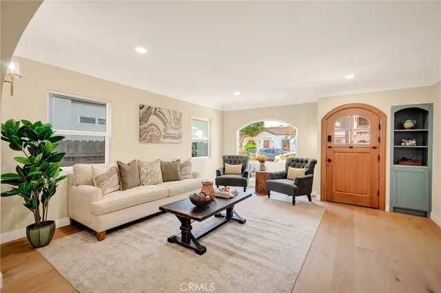 a living room with furniture and a potted plant