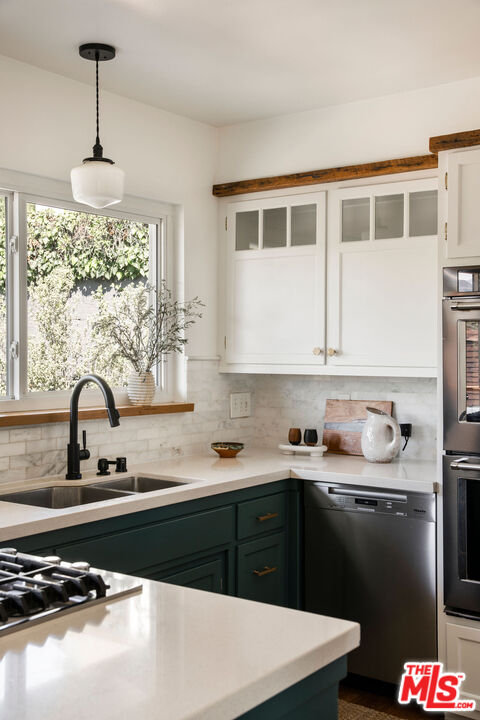 258 Redwood Drive Pasadena, CA 91105 - Photo 17 of 34 a kitchen with a sink stove and cabinets