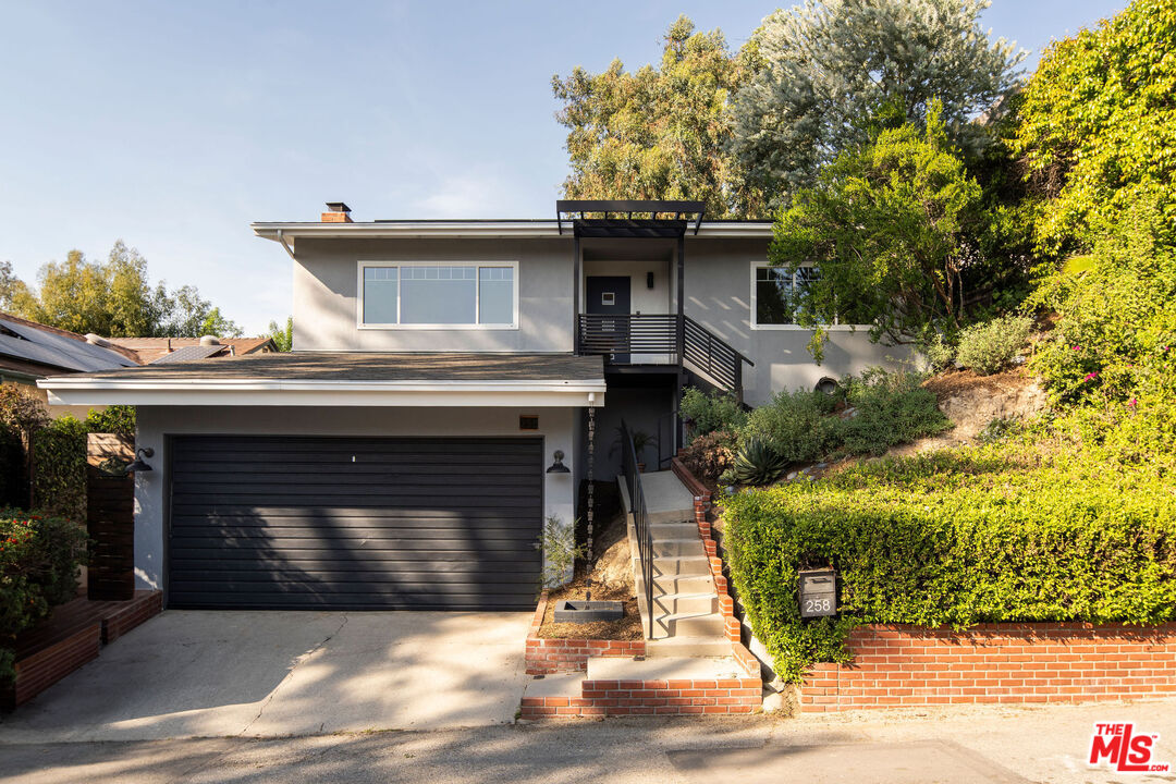 258 Redwood Drive Pasadena, CA 91105 - Photo 2 of 34 a front view of a house with a yard