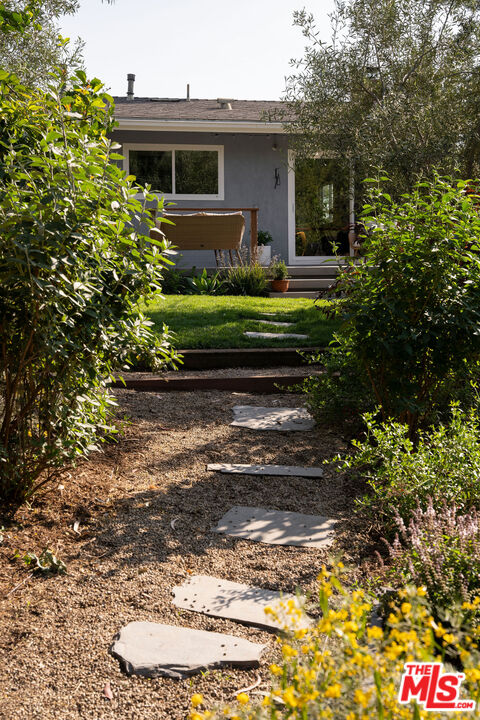 258 Redwood Drive Pasadena, CA 91105 - Photo 25 of 34 a front view of a house with a garden and trees