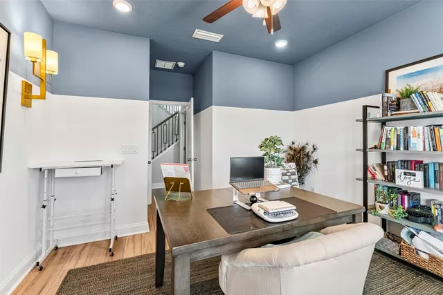 a living room with furniture and a book shelf