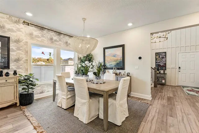 a dining room with furniture and wooden floor