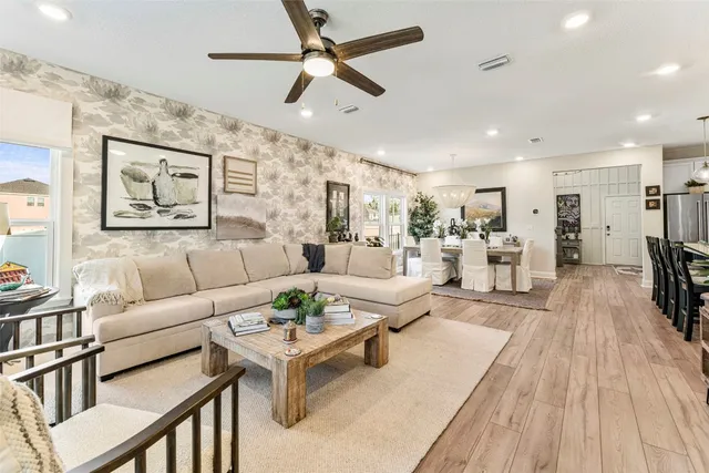 a living room with furniture and a view of kitchen