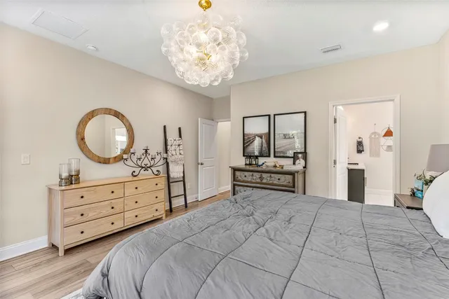a bedroom with a bed and a chandelier