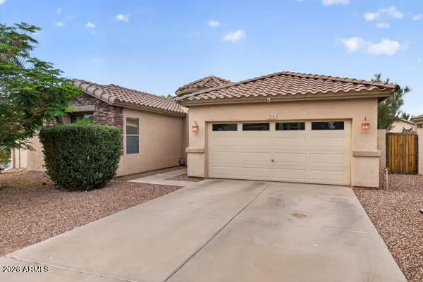 a view of a house with a yard and garage