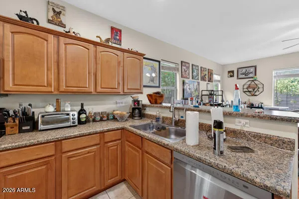 a kitchen with stainless steel appliances granite countertop a sink a stove a microwave and cabinets