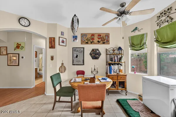 a dining room with furniture a kitchen and a chandelier