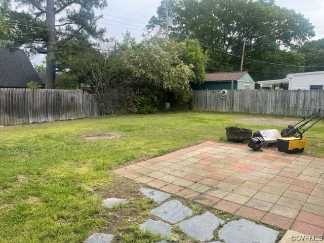 9504 Gayton Road Henrico, VA 23229 - Photo 8 of 8 a view of backyard with table and chairs and wooden fence