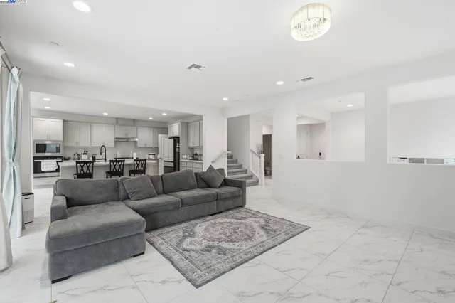 a kitchen with a dining table chairs and white cabinets