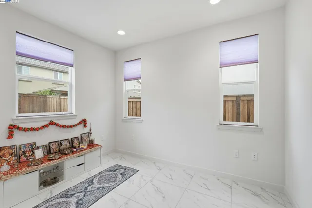 a living room with furniture a flat screen tv and window