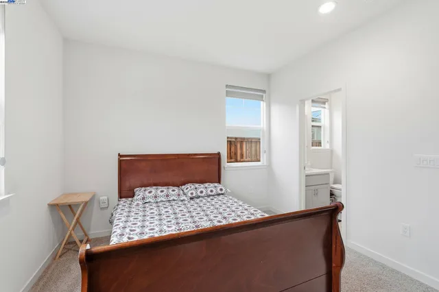 a bedroom with a large bed and a potted plant