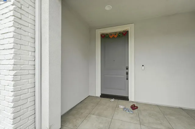 a view of a hallway with stairs and livingroom with furniture