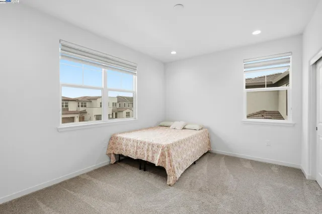 a bedroom with a bed and window