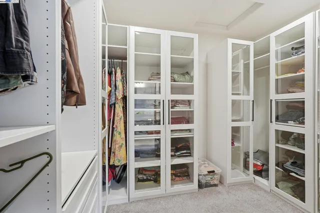 a utility room with dryer washer and a view of living room