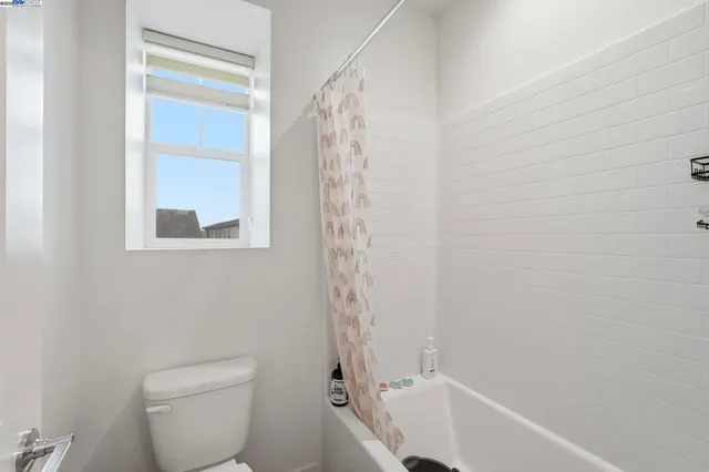 a view of an house with backyard and wooden fence