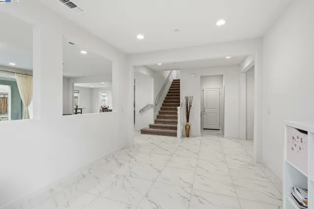 a living room with furniture a air conditioner vent and a window
