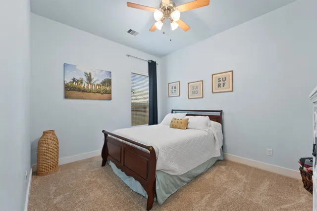 a bathroom with a sink a toilet a mirror a vanity and window