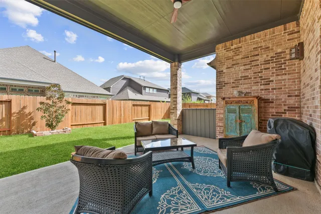 a view of a patio with a table and chairs and potted plants