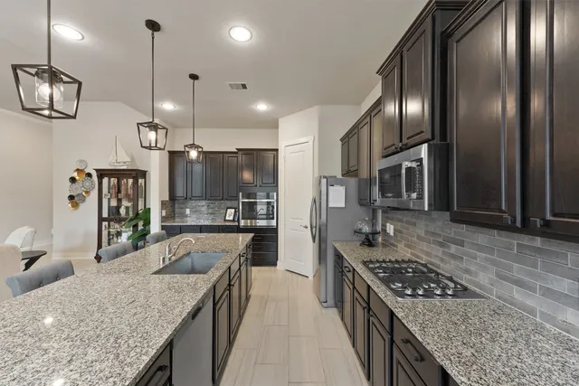 a large kitchen with a table and chairs