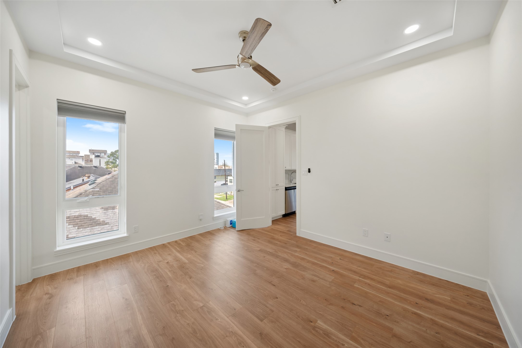 1839 Colquitt Street Houston, TX 77098 - Photo 10 of 19 Bedroom #2 is bright, spacious and features wood flooring, large windows for natural light, a ceiling fan, and recessed lighting. Ideal for a bedroom or office.