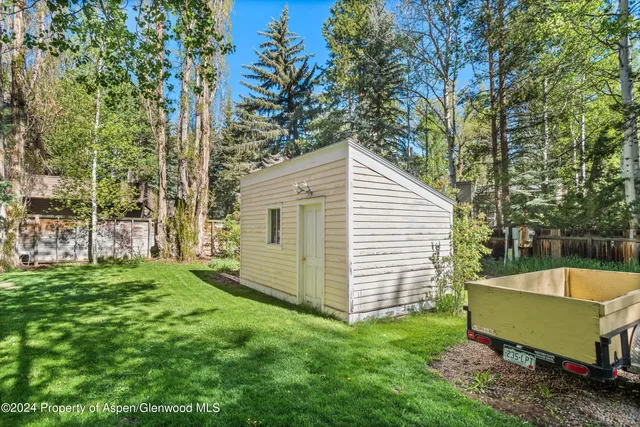 a view of a backyard with plants and a garden